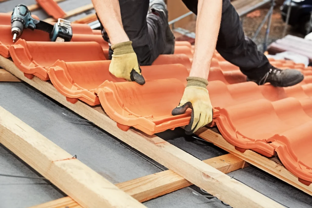 Used - close up to man installing red tiles