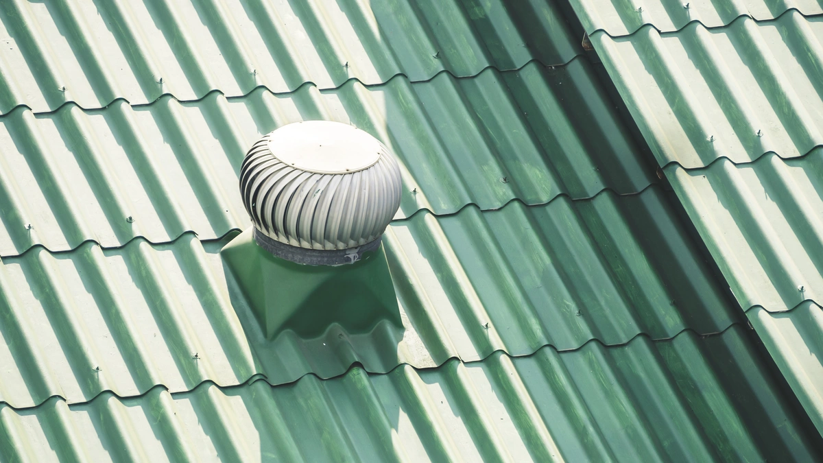 Used - close up to green metal roof turbine vent