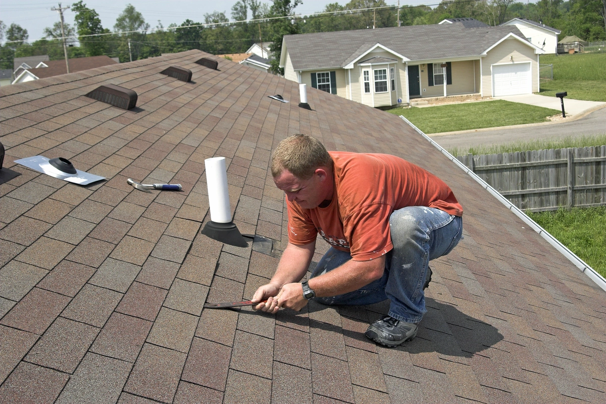 Close-up of a completed shingle repair on a residential rooftop: fresh shingles blending with the surrounding surface, bright natural daylight. Real G and Bros job site photo.