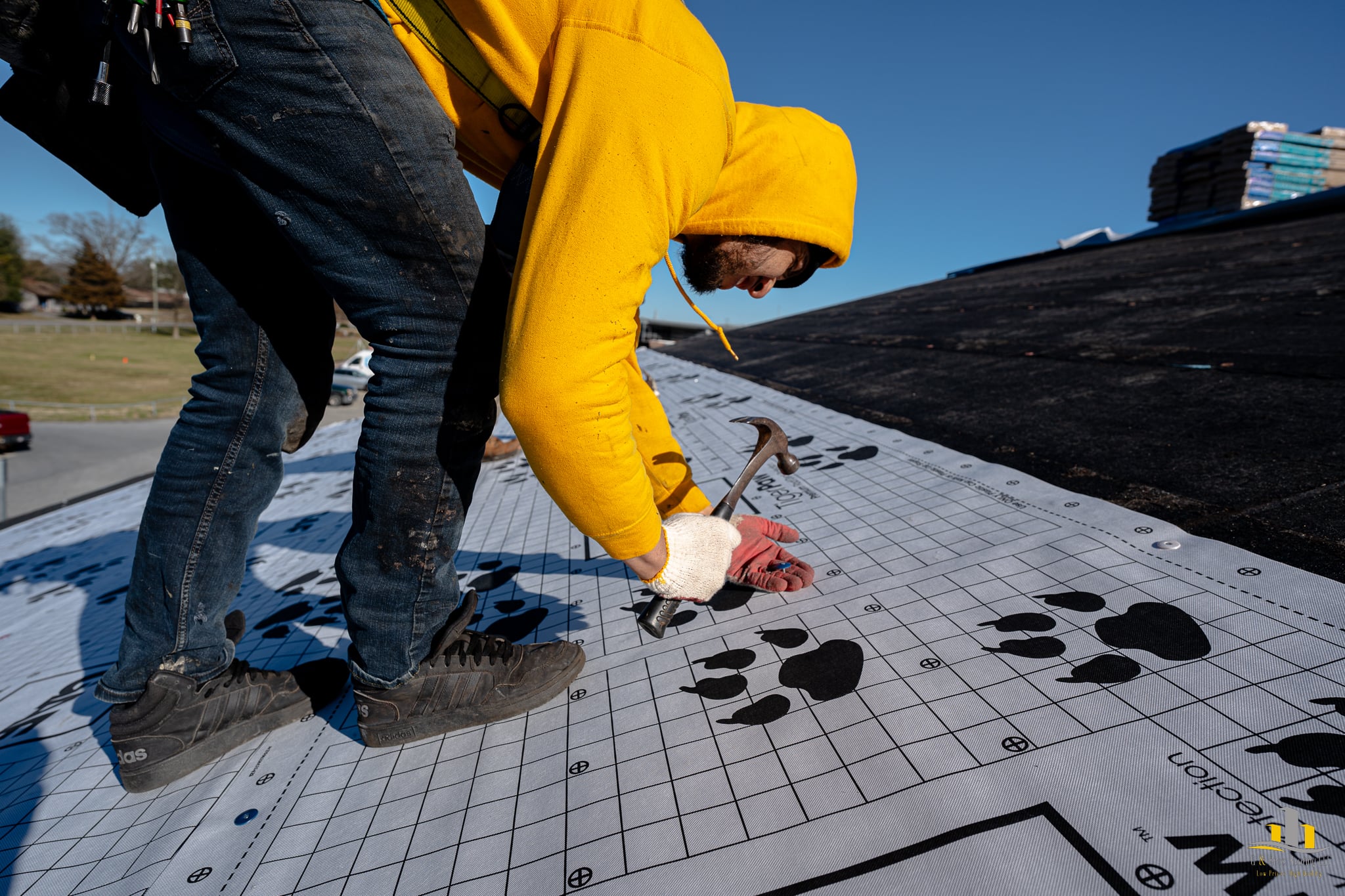 Used - Man installing cap nails on underlayment