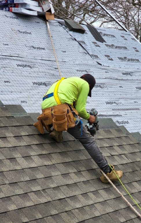 Used - G and Bros Roofing Contractor Salisbury MD. G and Bros Roofing employee tied off on a roof while installing GAF Timberline HDZ shingles on a roof.