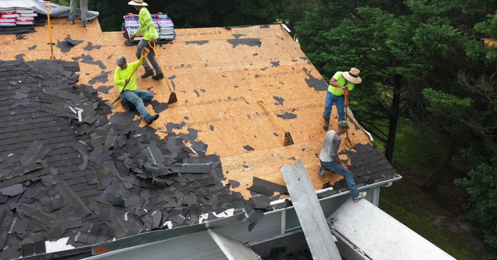 Used - Roofing contractors perform roof tear off before replacement G and Bros crew performing a full shingle roof replacement on a residential home on the Eastern Shore, removing old shingles and preparing the roof deck for new installation.