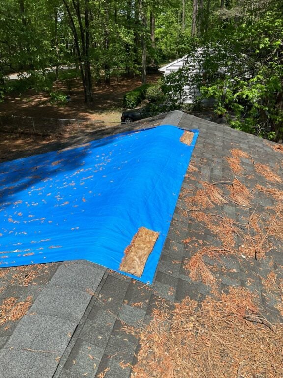 Used - Roof with a tarp due to wind damage. G and Bros a Roof Repair and Storm Restoration