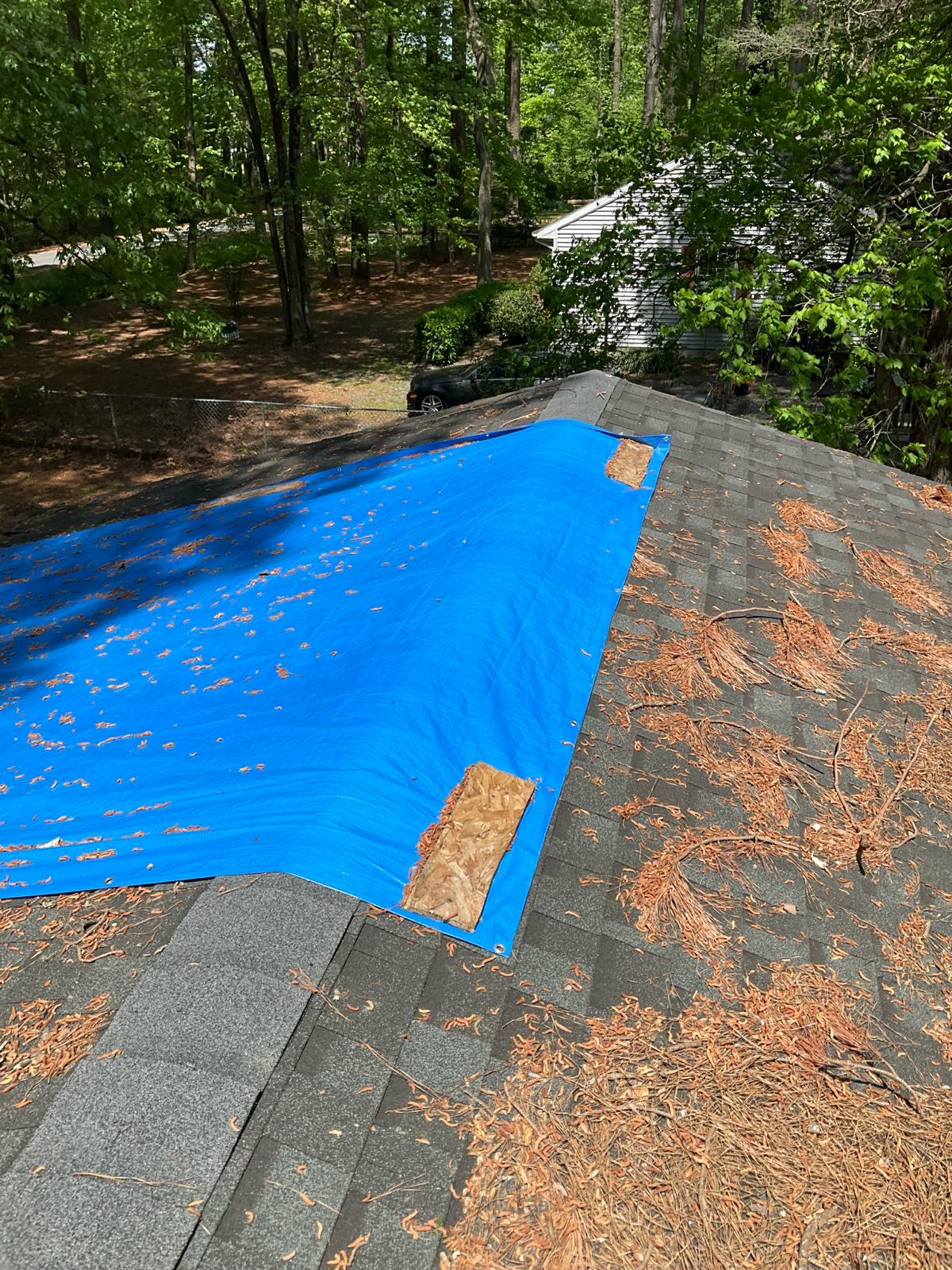 Used - Roof with a tarp due to wind damage. G and Bros Roofing Roof Repair and Storm Restoration