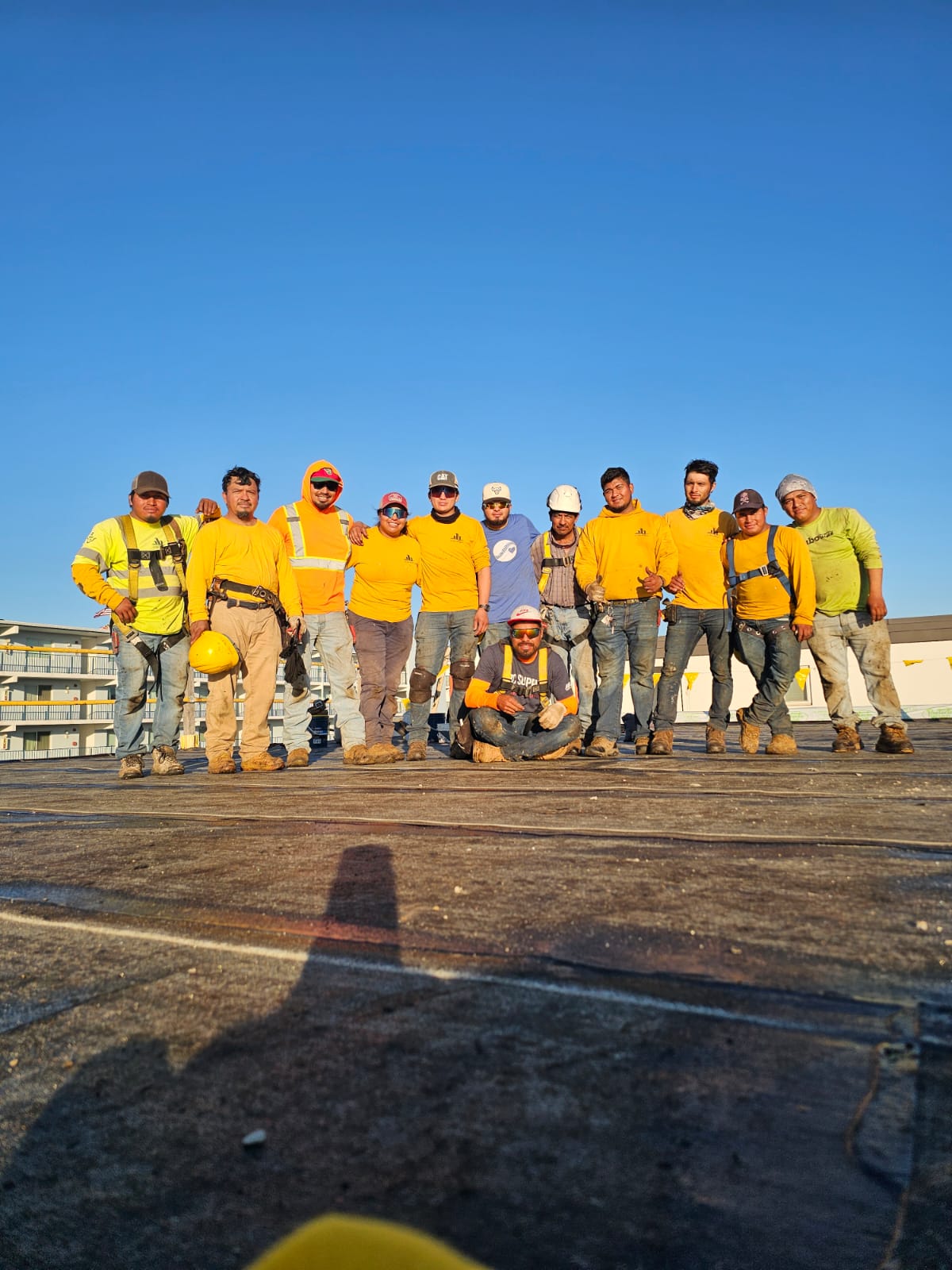 Used - G and Bros Employees 109 Clark Street, Salisbury MD 21804 Commercial Roofing Contractor Residential Roofing Contractor 12 G and Bros employees posed to take a group picture on the roof of a job site. They are all wearing the G and Bros uniform and smiling.