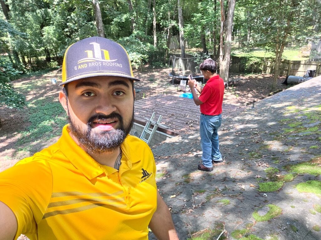 Storm Damage Roof Insurance Claims in Maryland: What Ocean Pines Homeowners Need to Know 4 | G and Bros Used - Guillermo Molina Matus taking a selfie on a roof while conducting a roof inspection with Yerik Molina Matus. G and Bros, a roofing contractor based in Salisbury MD