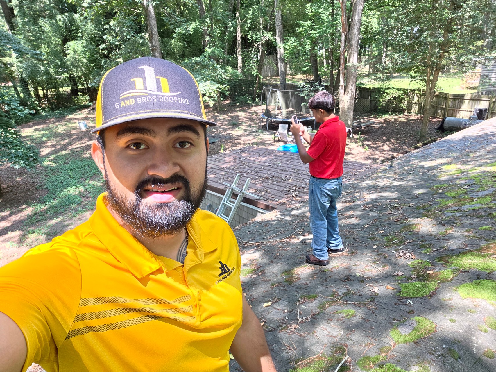 Used - Guillermo Molina Matus taking a selfie on a roof while conducting a roof inspection with Yerik Molina Matus. G and Bros Roofing, a roofing contractor based in Salisbury MD