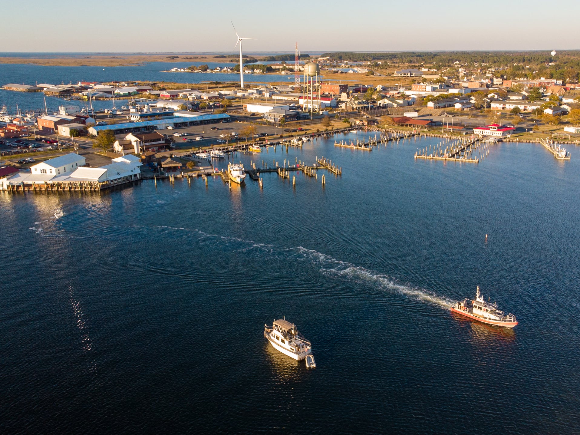Aerial view of Crisfield, Maryland waterfront, marina, fishing boats, harbor, and downtown near the Chesapeake Bay on Maryland’s Eastern Shore.