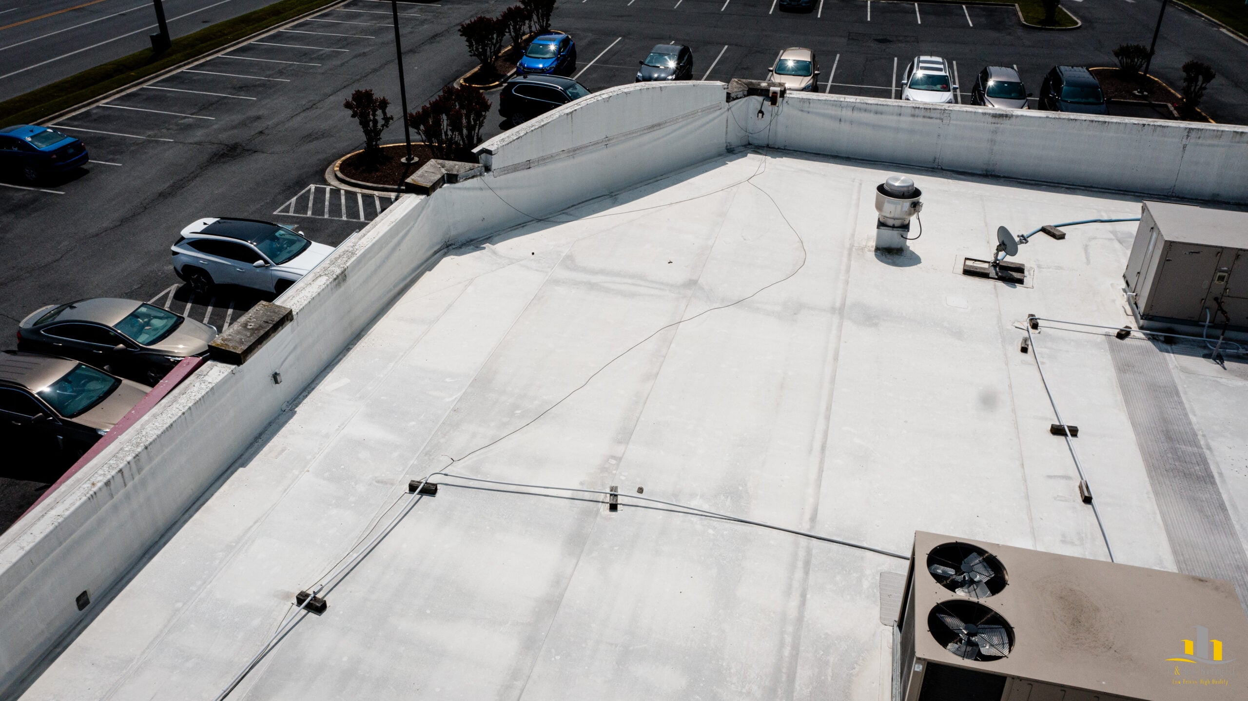 5 Warning Signs Your Commercial Roof Needs Replacement (Not Just Repair) 3 | G and Bros Aging TPO commercial flat roof on Delmarva showing weathered membrane and loose TPO along the parapet wall