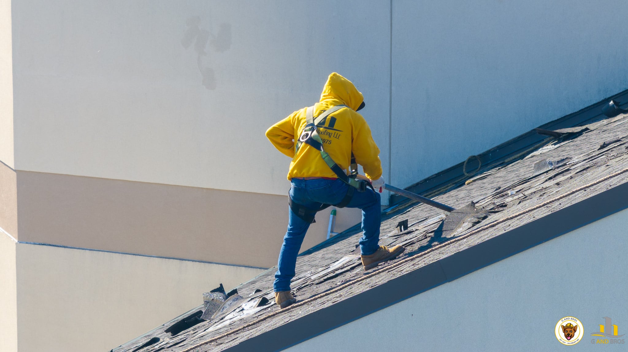 G and Bros crew member tearing off the existing upper roof at Emmanuel Wesleyan Church in Salisbury, Maryland down to the plywood roof deck