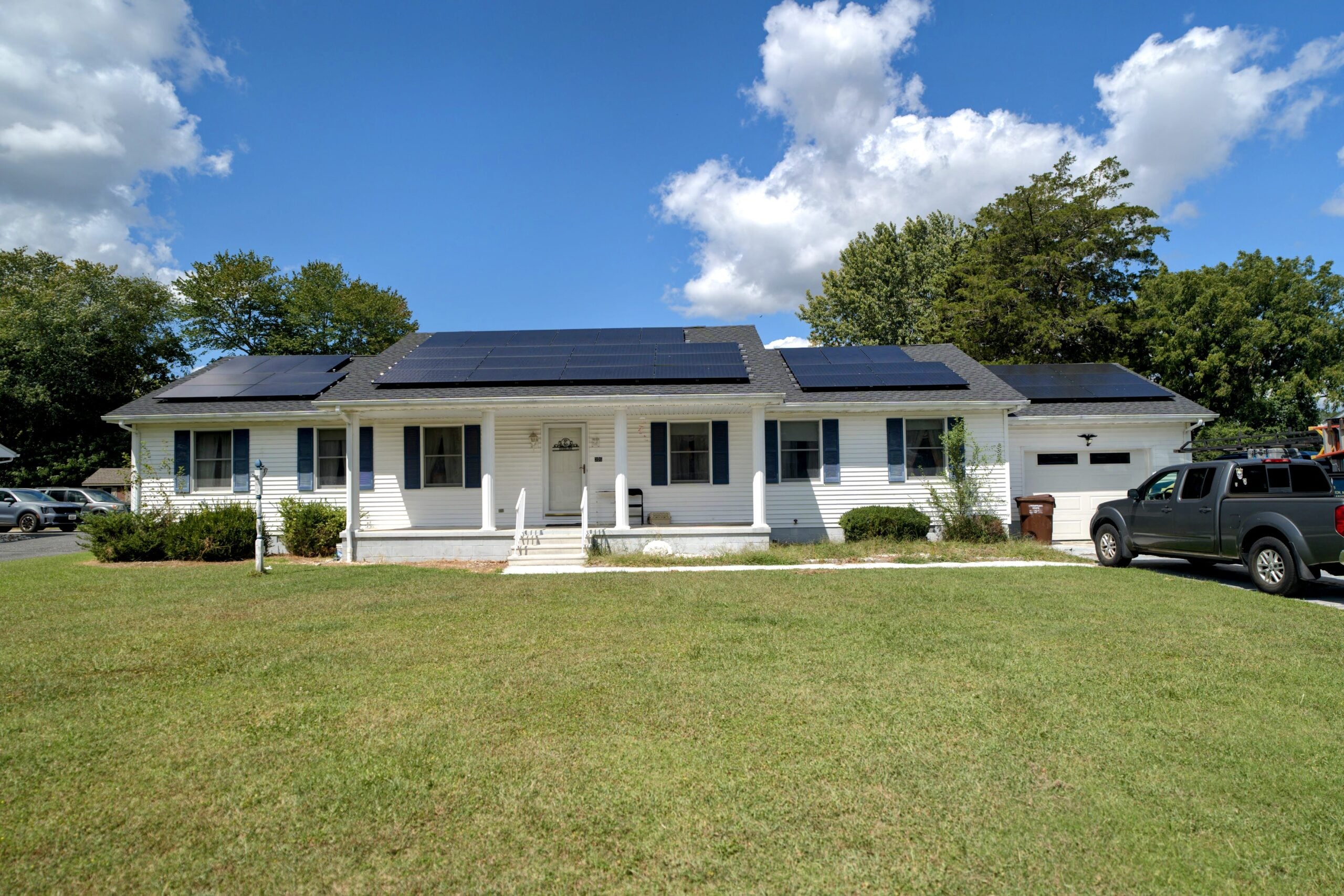 Solar Panels and Your Roof: What Every Delmarva Homeowner Should Know Before Installing 2 | G and Bros Aerial view of a Delmarva home with a solar panel array installed on an architectural shingle roof
